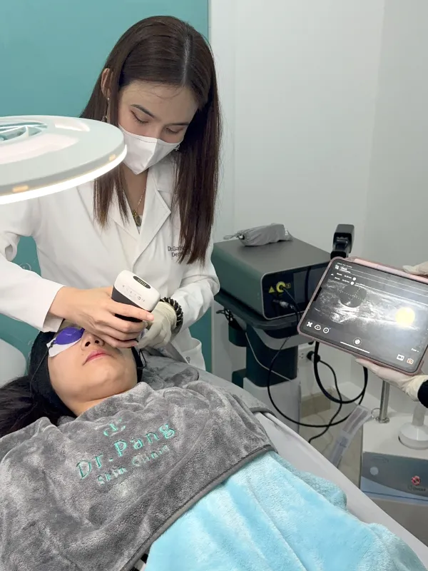 Doctor performing diagnostic ultrasound on patient at Dr. Pang Skin Clinic
