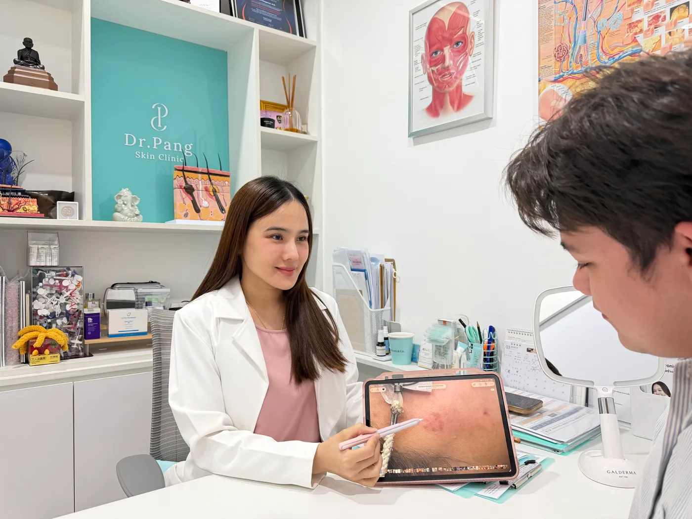 Dr. Gateorn Pongarnar conducting a skin cancer consultation and dermoscopy screening at Dr. Pang Skin Clinic Bangkok